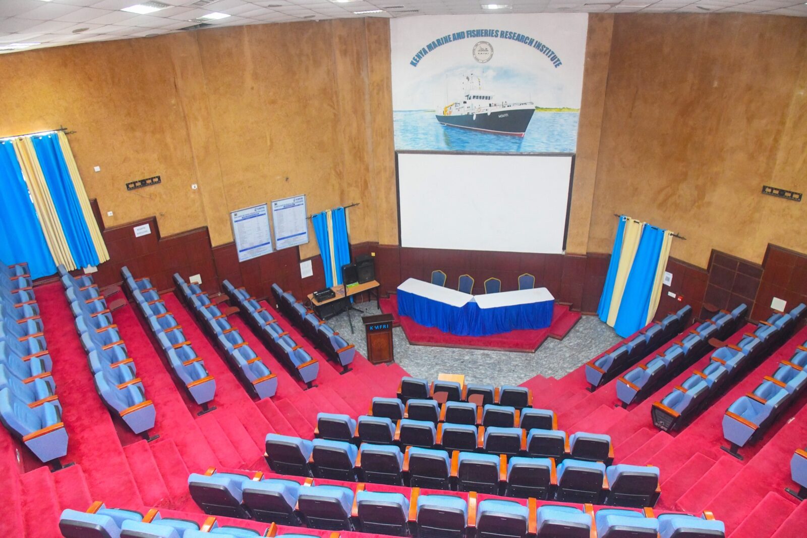 KMFRI Main Auditorium — full view of the hall, stage and tiered seating